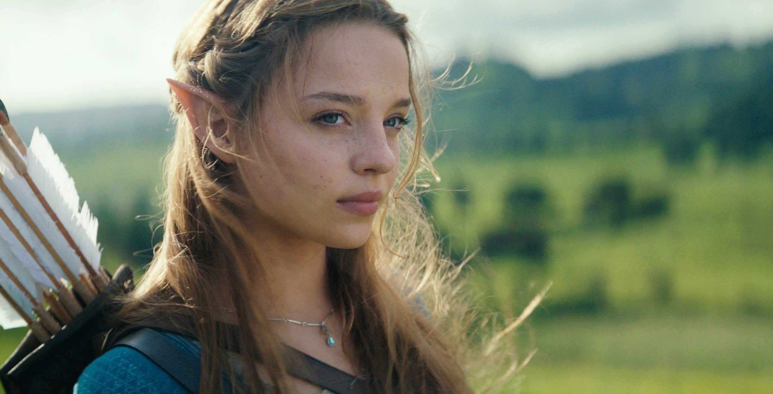 First-look photo of live-action Link and Princess Zelda standing in an open field from Nintendo’s Legend of Zelda movie.